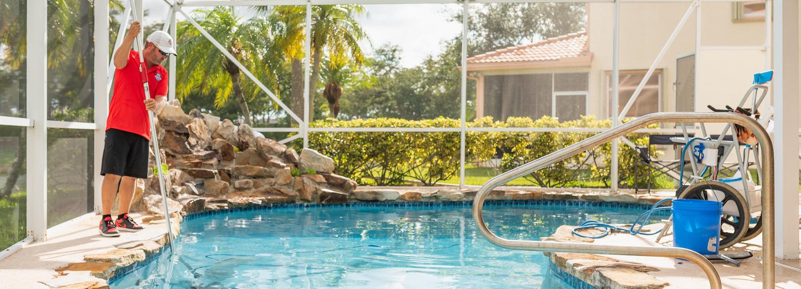 Pool Scouts owner cleaning a screened pool in Florida